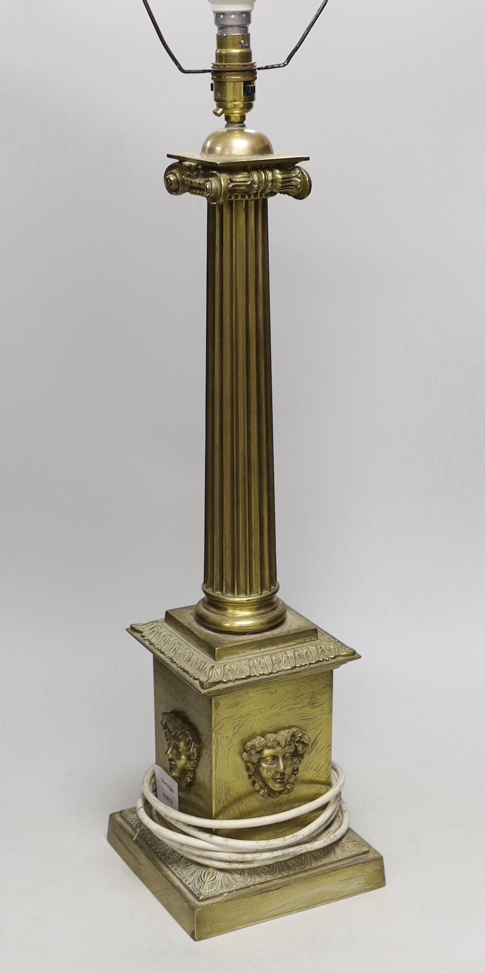 A large brass desk lamp in the form of a tapering column, on plinth base, 56cm to top of column